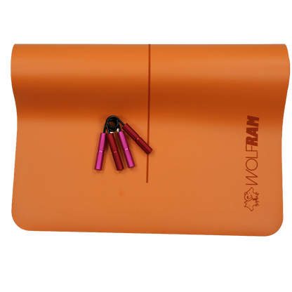 Orange Wolfram Fitness yoga mat paired with one pink and one red hand grip, showcasing mixed-resistance grip trainers for wrist and forearm conditioning.