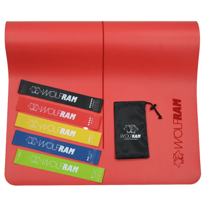 Red Wolfram Fitness yoga mat displaying a 5-piece set of latex booty bands in varying resistance levels, arranged neatly with the carry bag.